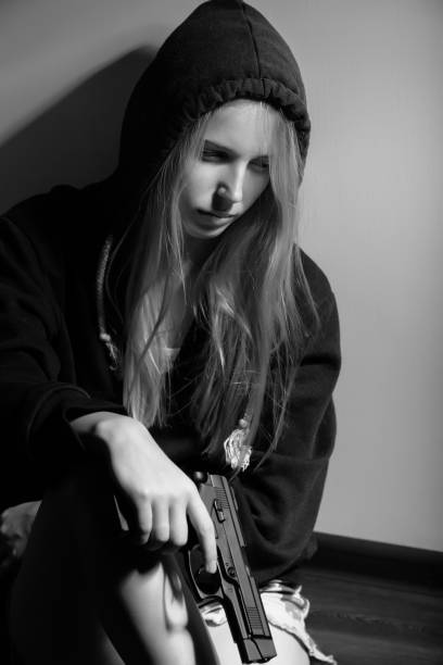 istock woman with gun 1430874171