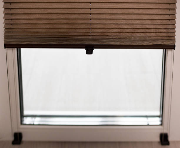 istock Pleated blinds close up on the window in the interior 1430874237