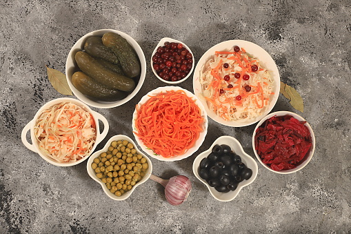 Food background, Fermented products on a concrete table, advertising banner, healthy food concept, sauerkraut, kimchi, pickled beets, cucumbers, peas, olives, natural products for weight loss, top view, selective focus