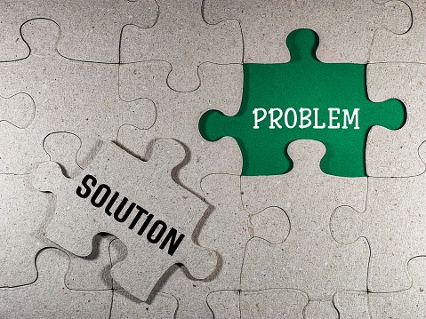 Management concept with puzzle piece with problem solving and solution.