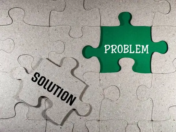 Management concept with puzzle piece with problem solving and solution.