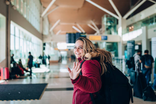 Happy woman at airport stock photo