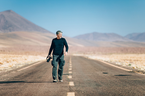 Photographer on an empty road at Atacama desert