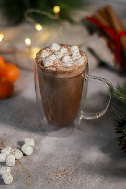 istock hot chocolate in a glass mug with mini marshmallows on grey table, blurred xmas background 1430886101
