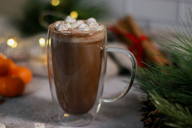 istock hot chocolate in a glass mug with mini marshmallows on grey table, blurred xmas background 1430886108