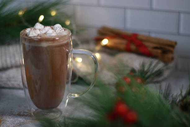 istock hot chocolate in a glass mug with mini marshmallows on grey table, blurred xmas background 1430886119