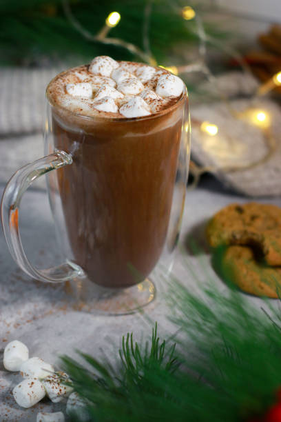 istock hot chocolate in a glass mug with mini marshmallows on grey table, blurred xmas background 1430886130
