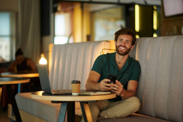 istock Startup, creative and businessman with 5g phone working for communication, networking and web search or planning in cafe. Happy, tech and digital strategy for social media or contact us with smile. 1430888047