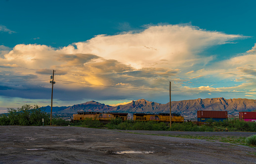 Freight train passing alongside Puerto de Anapra town at the border between USA and Mexico