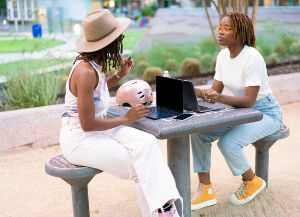 istock Freelancer sisters making the public park be their office 1430890099