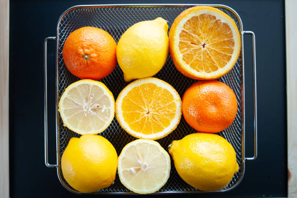 istock Fresh oranges and lemons in a tray on a table, top view. Citrus fruit concept 1430890513