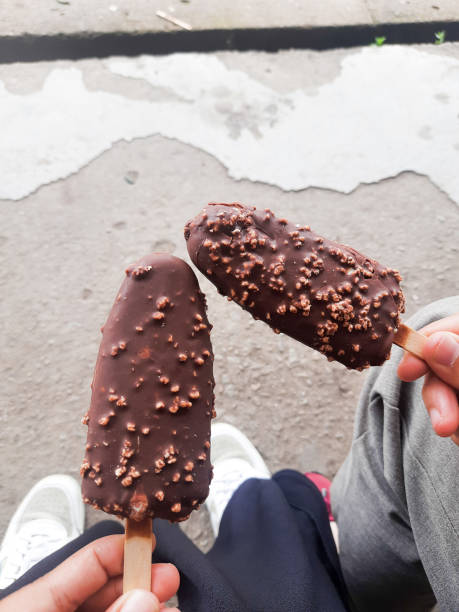 istock two friends enjoying chocolate popsicles 1430896468