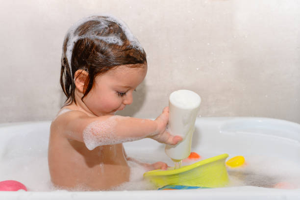 istock Girl playing with water in a bathtub 1430905664