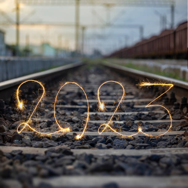 Number 2023 written sparkling sparklers on railway tracks