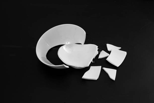 istock broken to pieces white bowl, isolated on black 1430907389