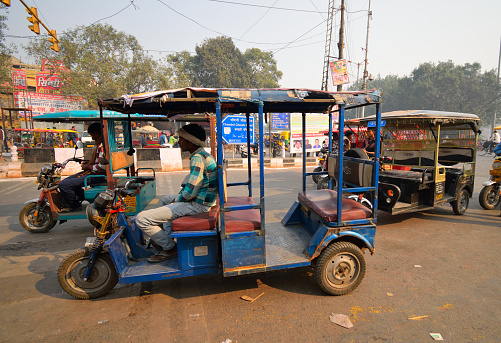 Delhi, India - November 20, 2017: An e-rickshaw or electronic rickshaw waiting for passengers in the road.