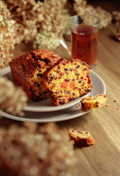 istock Fruit cake and tea on a wooden table with dried flowers. 1430910633