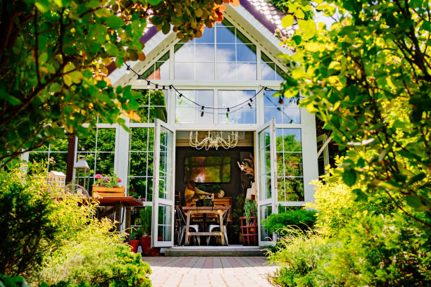 istock beautiful house with large panoramic windows surrounded by greenery. 1430913944