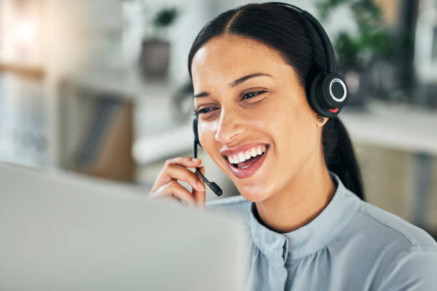 istock Female customer service representative using headset and consulting clients online. Call center concept. Smiling young woman with headset doing video call and working from home. Helpdesk and hotline. 1430914180