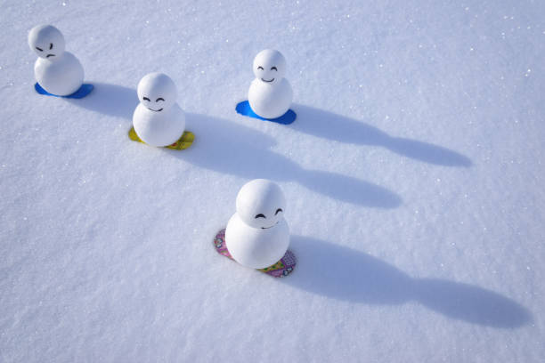 Snowman snowboarding down the slopes