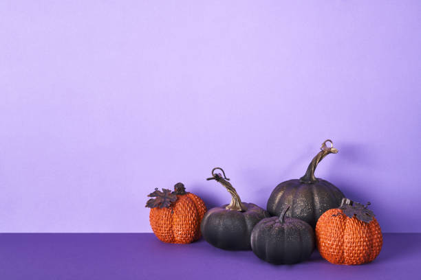 istock Halloween composition with pumpkins on violet background. Greeting card template, Halloween decorations 1430915049