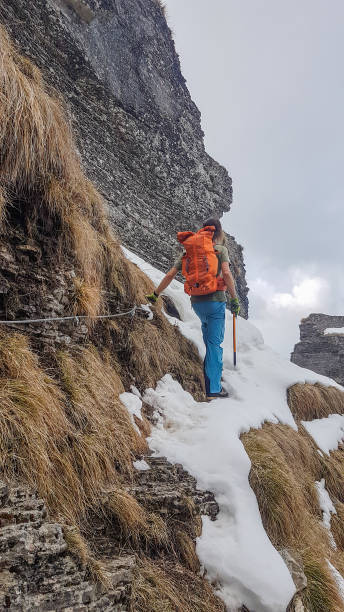 istock Alpinist moving on a snowy mountain crest 1430915780