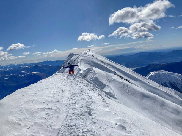istock Alpinist moving on a snowy mountain crest 1430915835