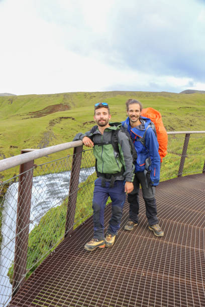 istock Two hikers posing in front of a waterfalls 1430918399