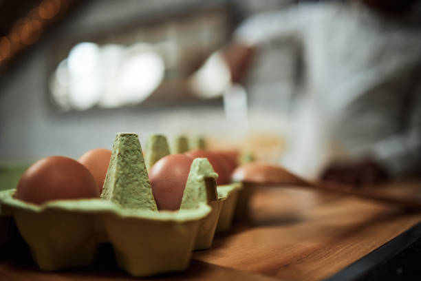 Close up of eggs in carton at dining table. Copy space.