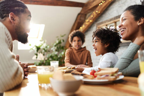 istock Happy black parents and their kids talking during breakfast. 1430926091