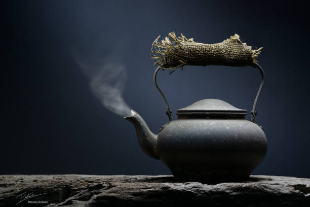 Black metal kettle with steam still life fine art