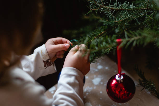 istock Children hands decorating Christmas tree at home 1430935093