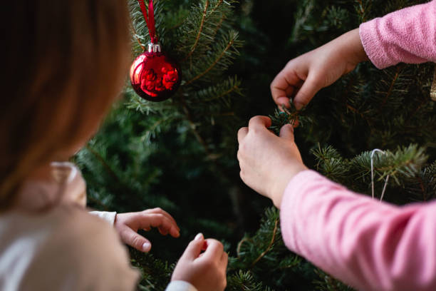 istock Children hands decorating Christmas tree at home 1430935289