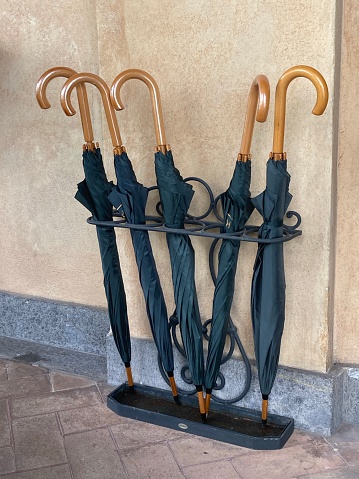 Five Black Umbrellas in. Stand in A Corridor