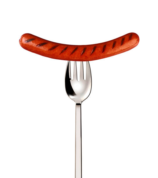 istock Close-up of fried sausage on a fork isolated on white background 1430937566