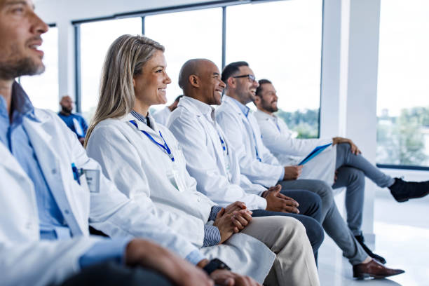 istock Happy medical experts attending an education event in board room. 1430939901