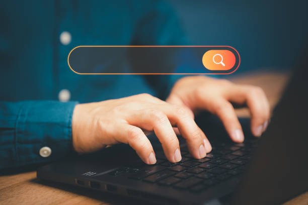 istock Freelance's hand working with computer laptop on desk in home. Searching Browsing Internet Data Information with blank search bar. Search Engine Optimization SEO Networking Concept. 1430939986