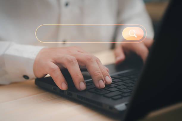 istock Freelance's hand working with computer laptop on desk in home. Searching Browsing Internet Data Information with blank search bar. Search Engine Optimization SEO Networking Concept. 1430939994