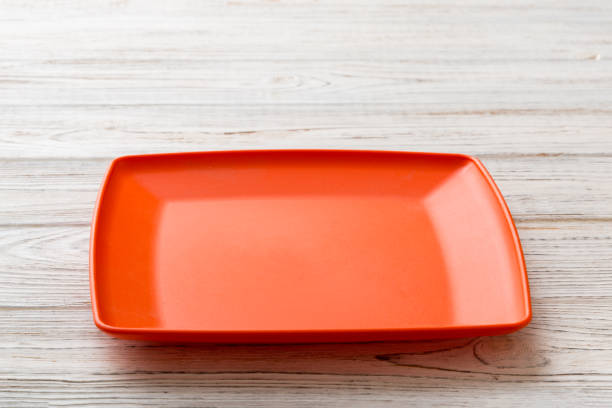 istock Perspective view of empty square plate on wooden background. Empty space for your design 1430941461