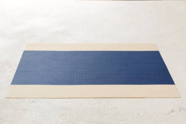 Perspective view of blue tablecloth for food on cement background. Empty space for your design.