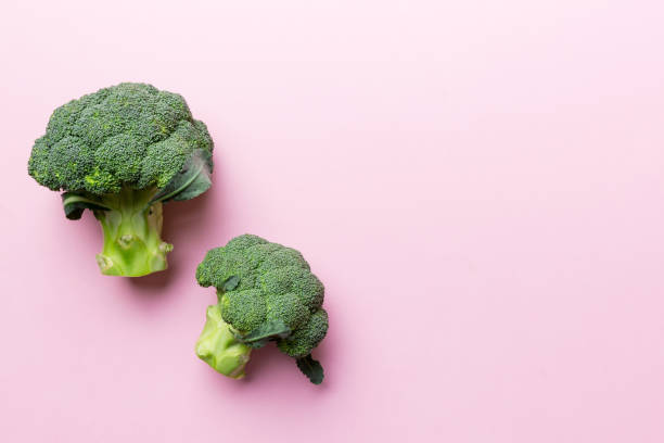 istock Top view fresh green broccoli vegetable on Colored background. Broccoli cabbage head Healthy or vegetarian food concept. Flat lay. Copy space 1430941679