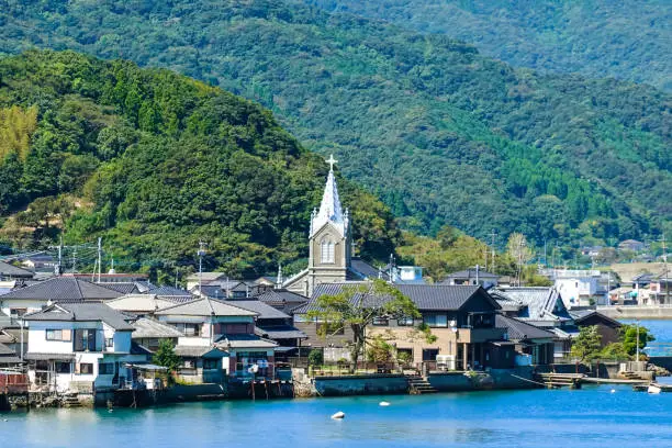 Catholic Sakitsu Church and streets of Sakitsu across Yokaku Bay in Sakitsu, Amakusa City, Kumamoto Prefecture on a sunny day in September 2022