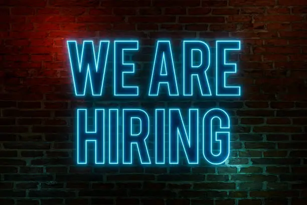 Photo of We are hiring, neon sign.