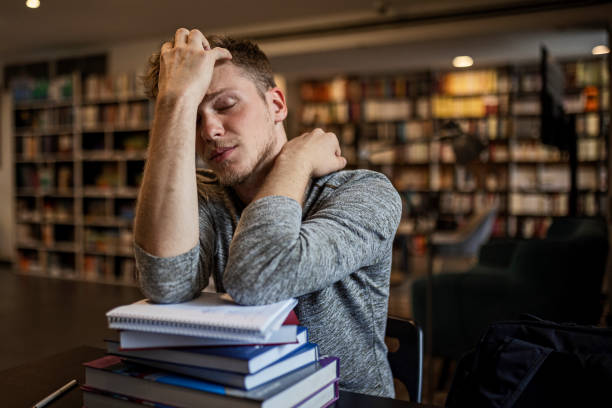 istock Student in library is tired and sleepy 1430944317