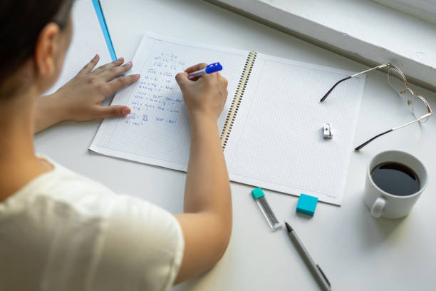 istock Student girl writing in her notebook at table 1430944987