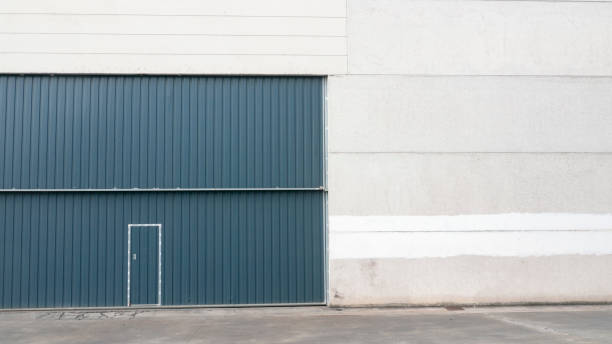istock Corrugated metal door in concrete hangar 1430946587