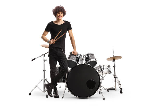 istock Young male drummer standing next to a drum kit and holding drumsticks 1430949317