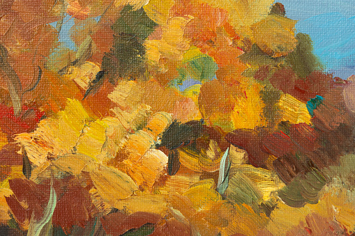 Abstract background autumn painting. Orange brown yellow beige mixed colors of oil paint. A fragment of an artwork in different shades of autumn shades. Modern handmade design with a brush on canvas