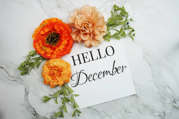istock Hello December text with orange flower bouquet on marble background 1430954919