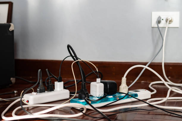 Multi-socket Power Strip with plugs  and damaged cords stock photo